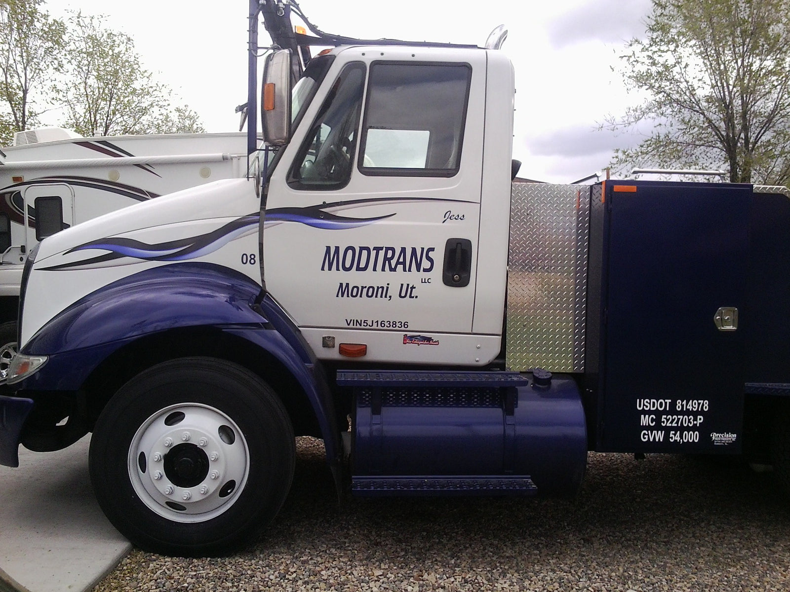 blue spear vinyl graphic on the front of a white semi truck