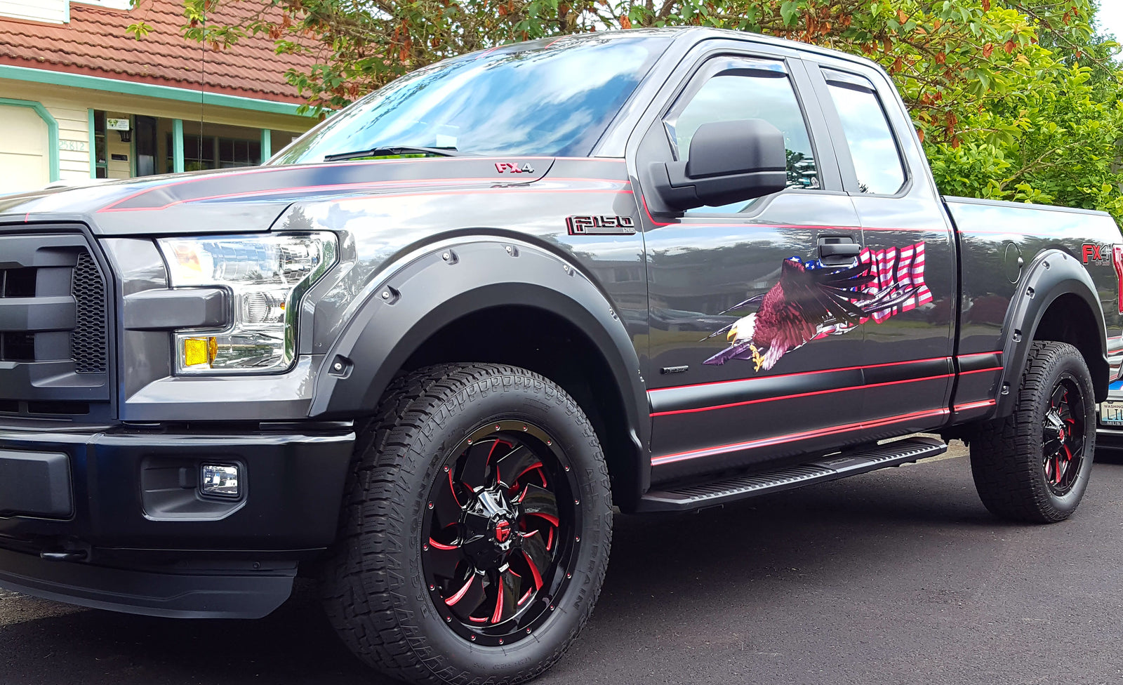 American flag with bald eagle decal on the side of gray Ford f150 pickup