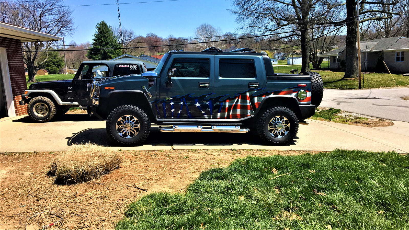 waving American flag decal on bottom half of blue H2 Hummer