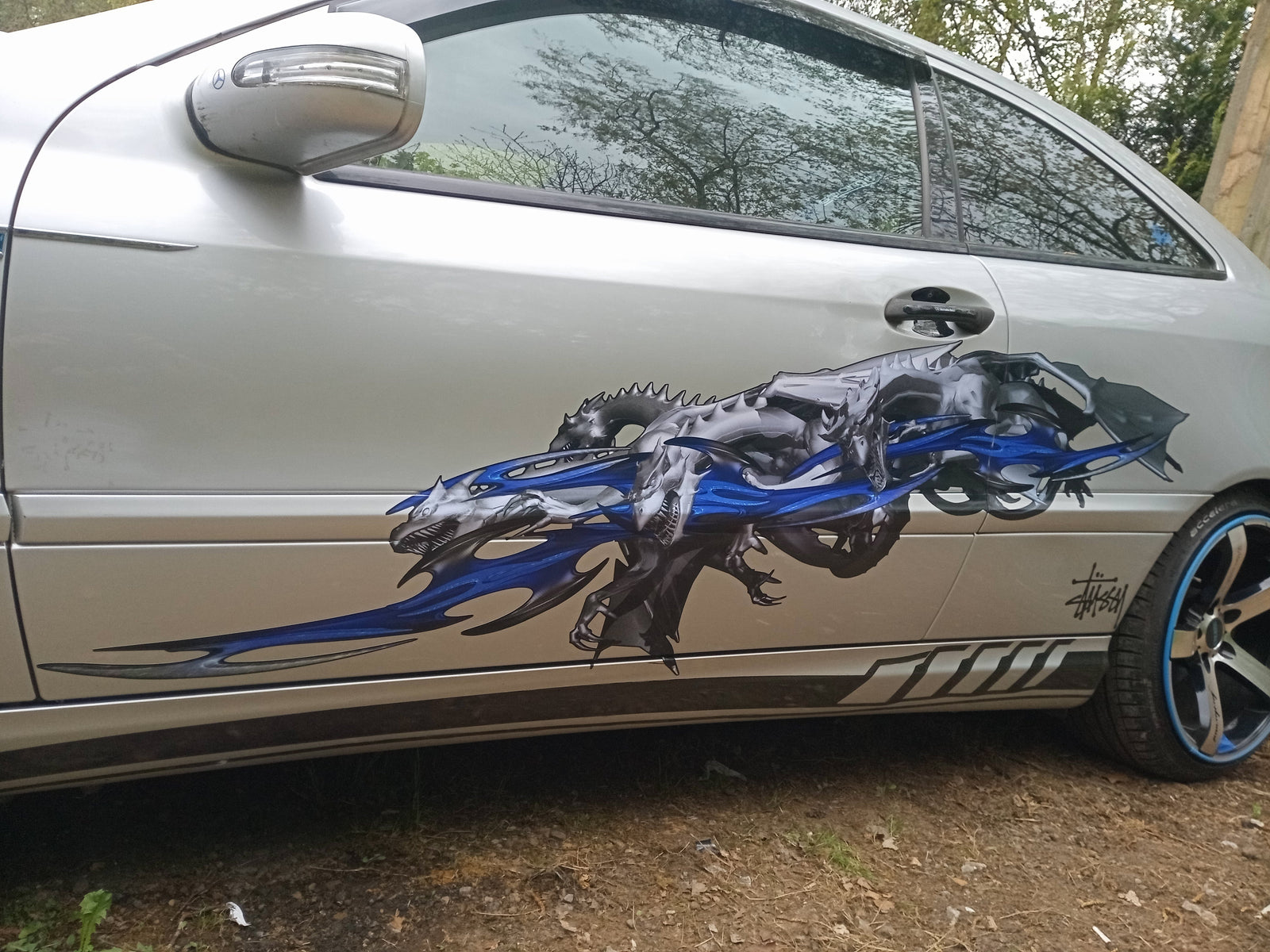 Tribal dragon graphic decal on the side of mercedes slk sports car