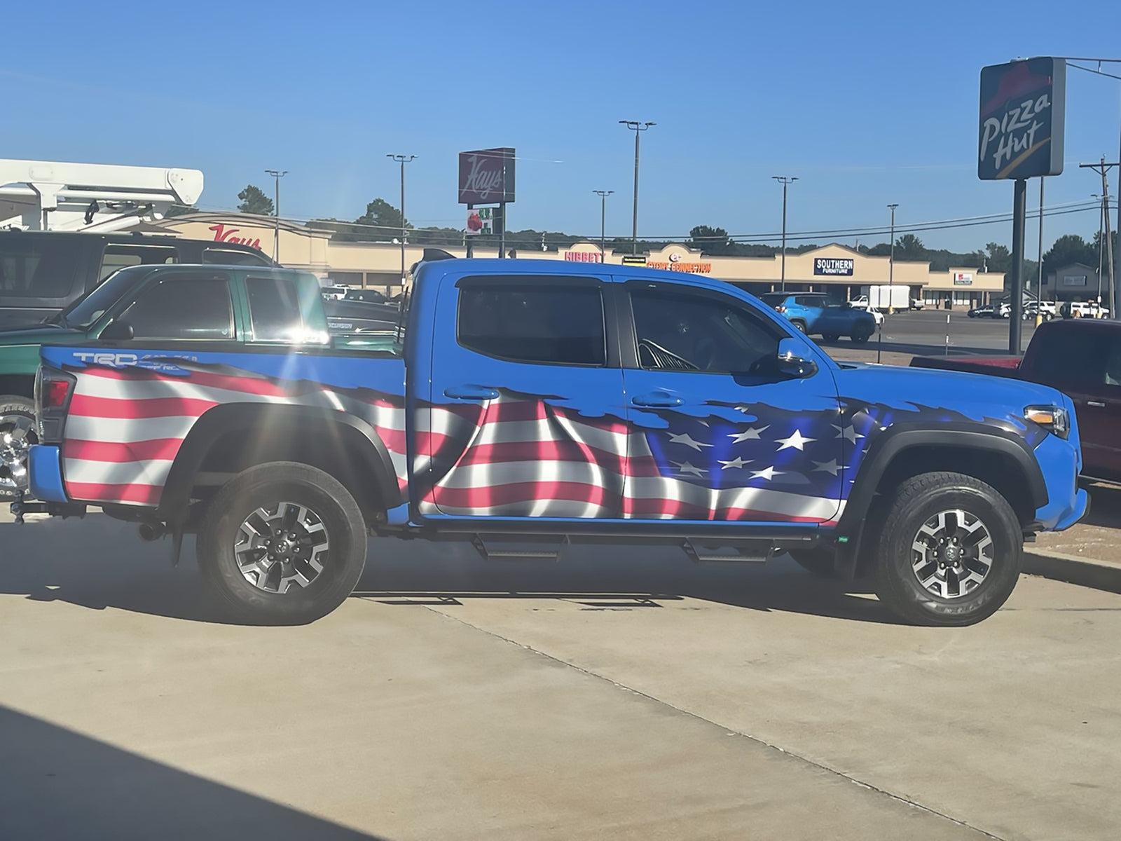 american flag wrap on blue toyota tacoma truck
