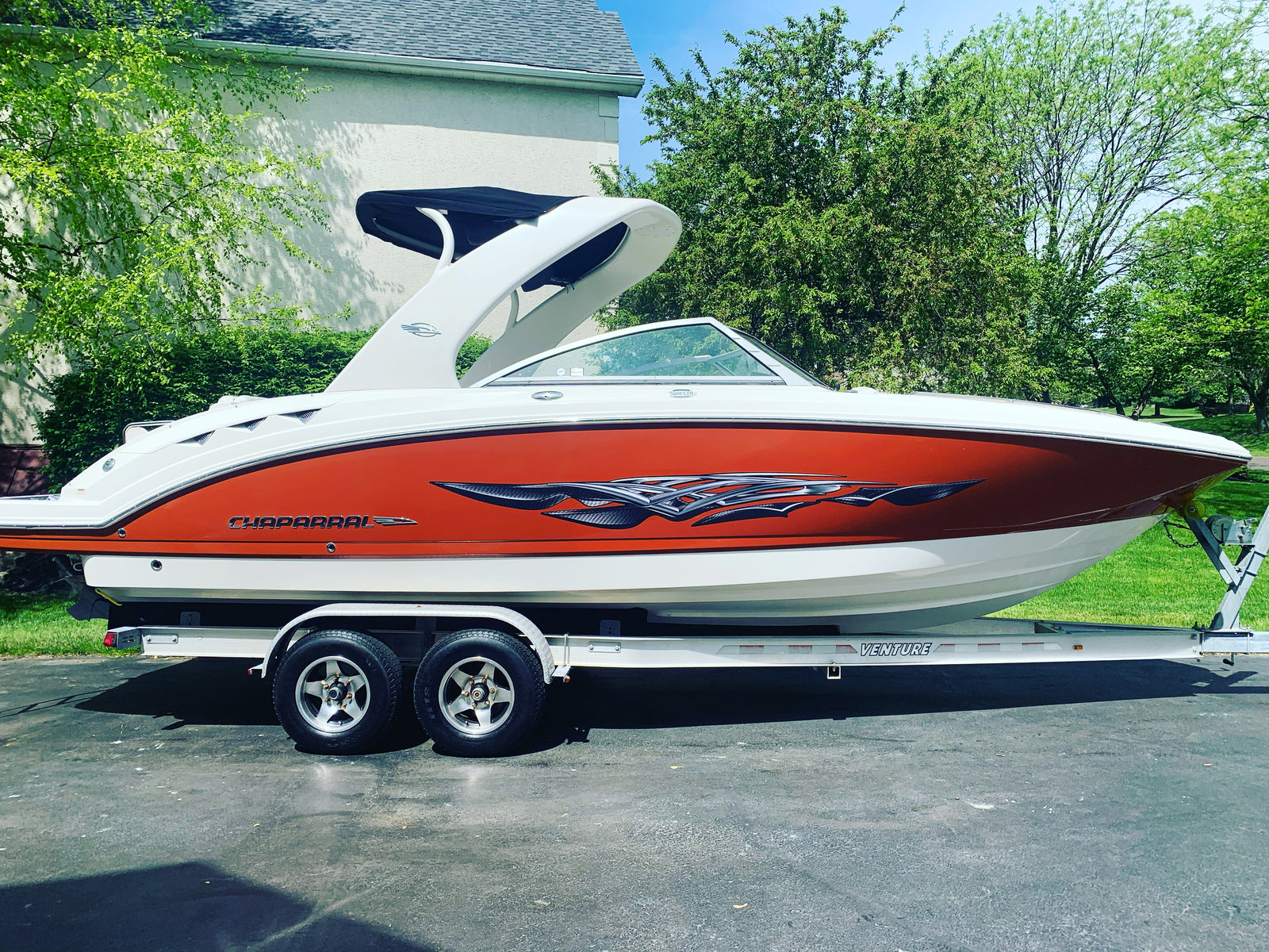 carbon fiber spears vinyl decal on the side of a red and white boat