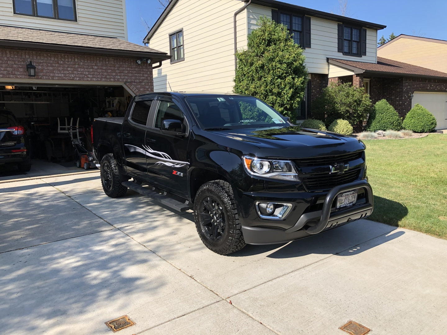 silver dart vinyl decal on black Chevy pickup truck