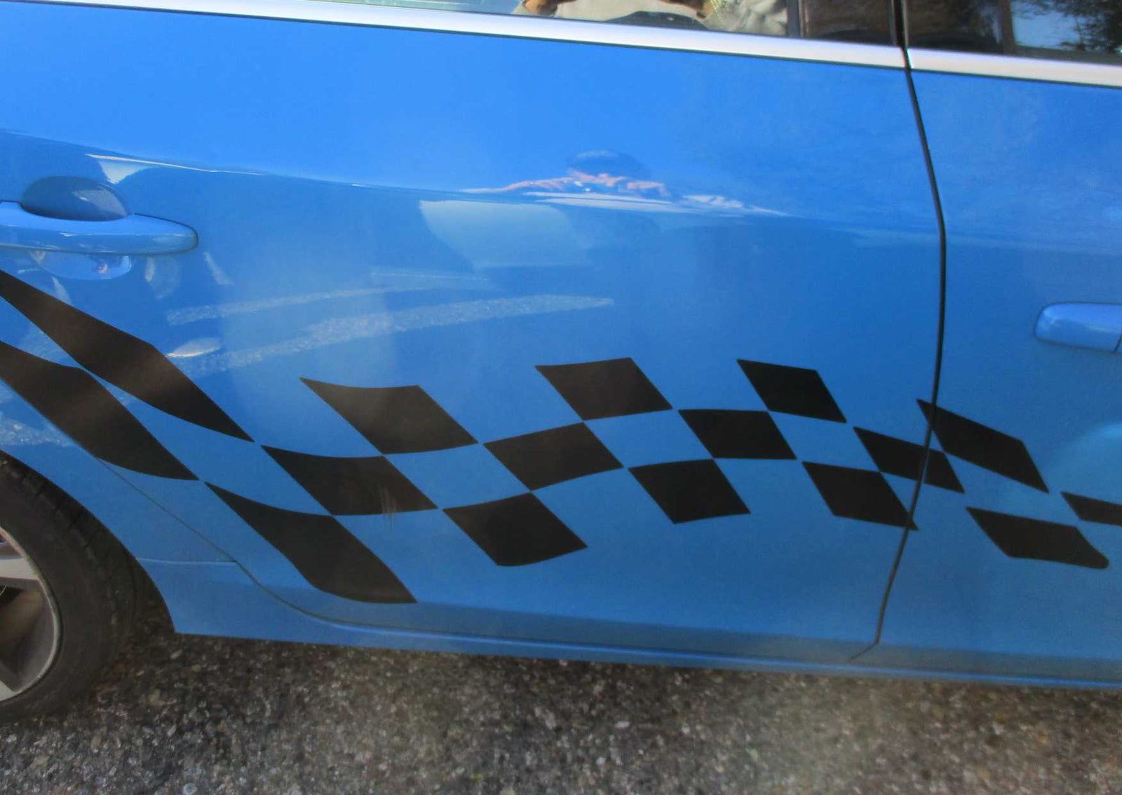 matte black vinyl checkered flag decal on the side of blue car