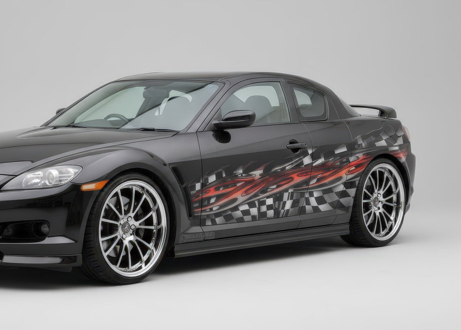 Sports car with tribal checkered flag vinyl half wrap on driver side