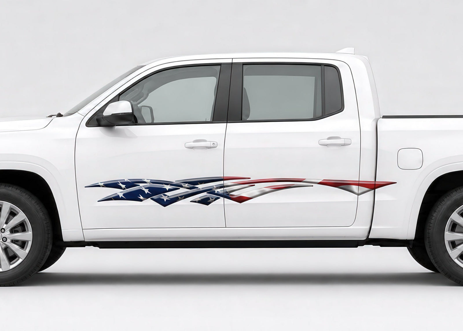 A white pickup truck shown in side profile on a light gray studio background, with a stylized American flag graphic decal running along the lower side panel.