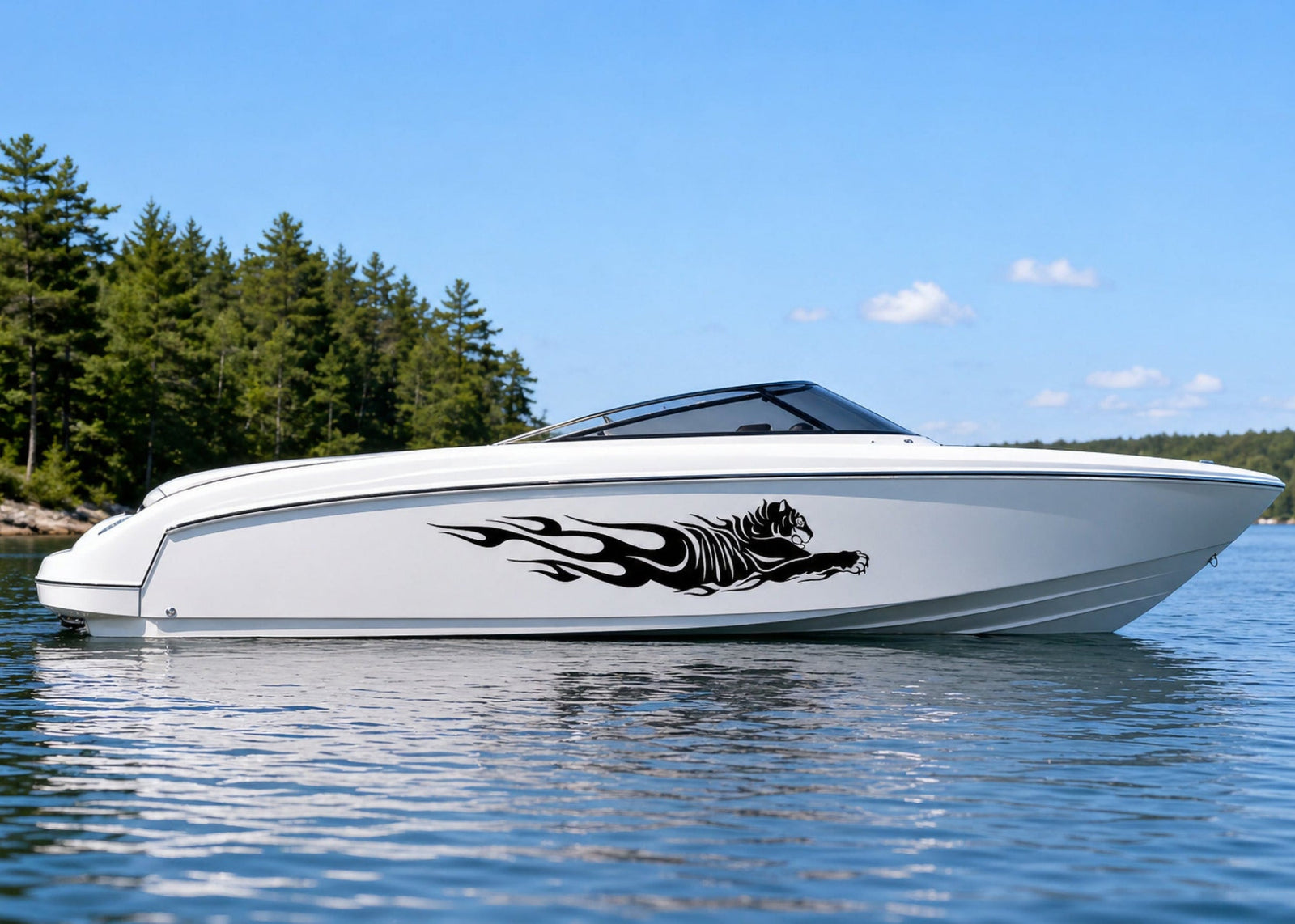 White speedboat on a lake with black Tiger Flames vinyl boat decal placed on the side hull.