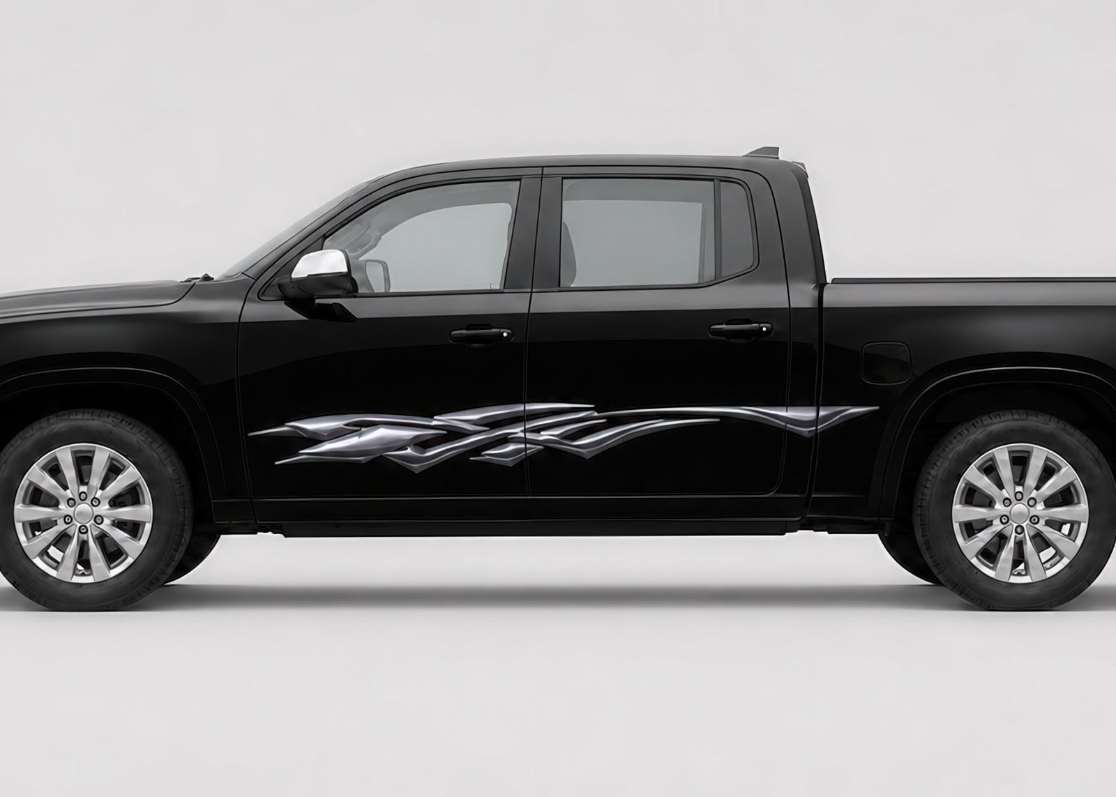 A black pickup truck shown in a side profile view against a light gray studio background. The truck features a chrome graphic decal on the side door.