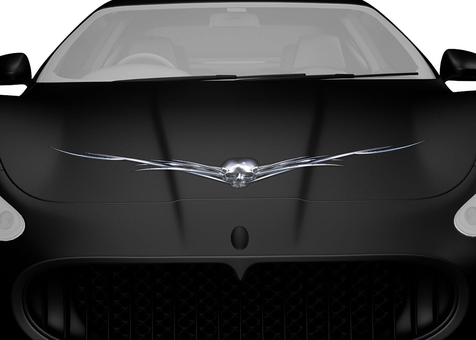 black sports car hood with chrome horned skull decal on it