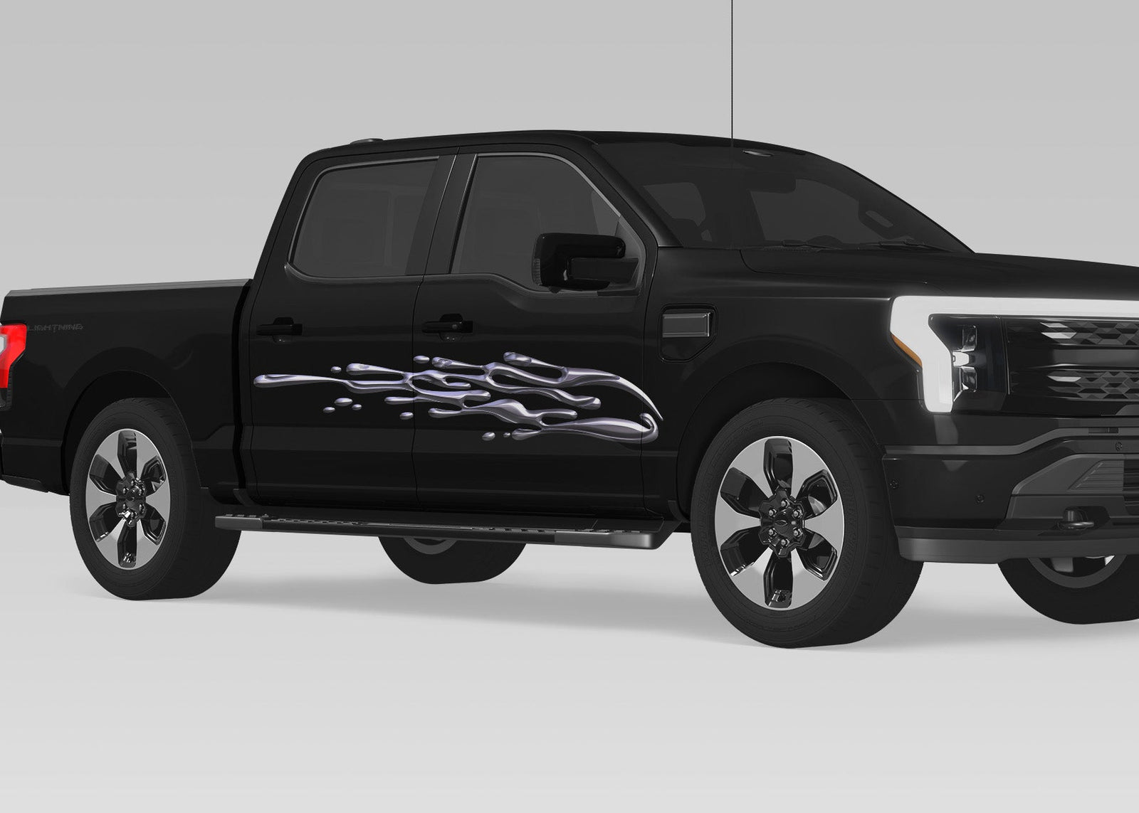 black truck with chrome mud splash vinyl graphics on passenger side