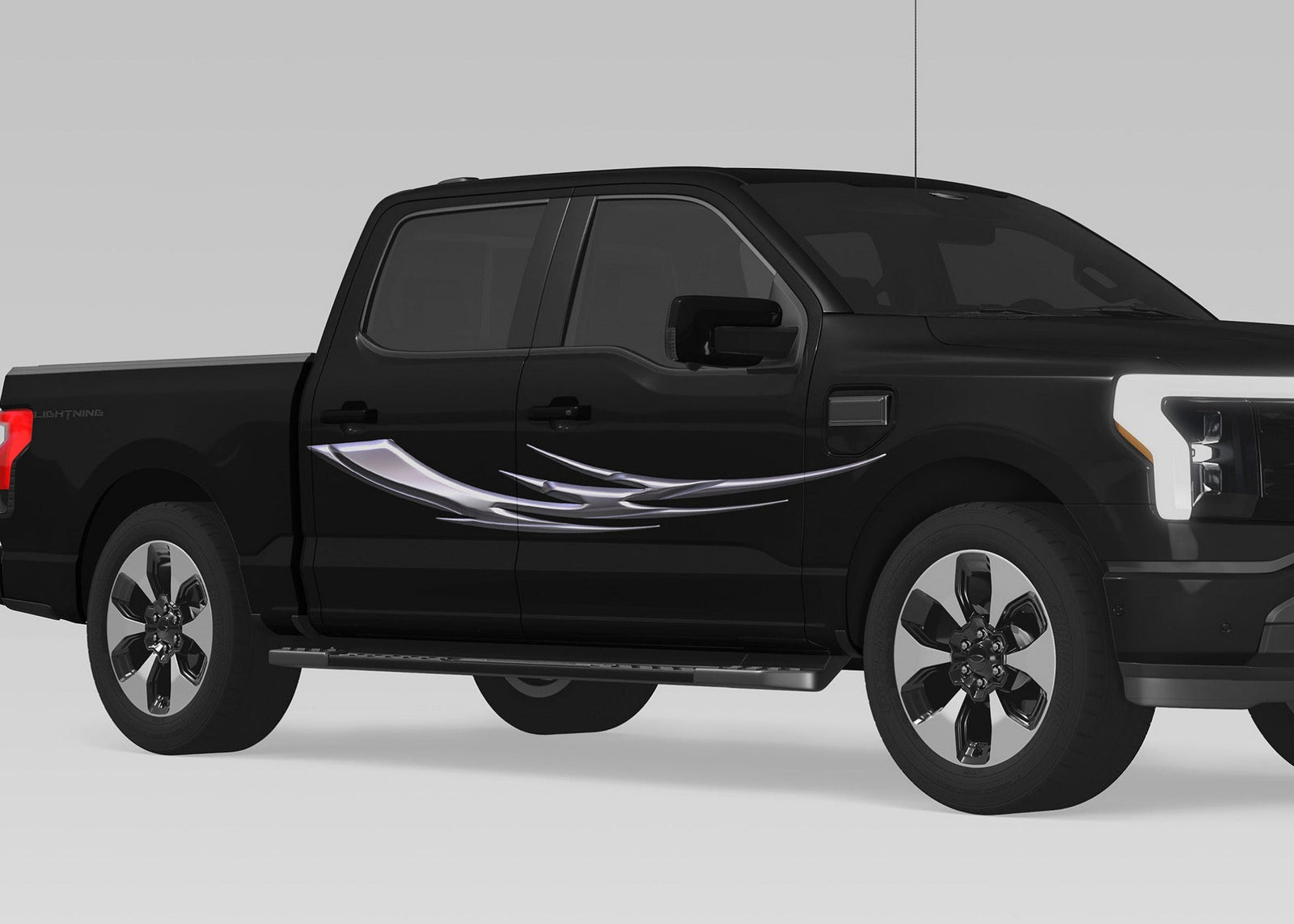 black truck with chrome tribal blade vinyl graphics on passenger side