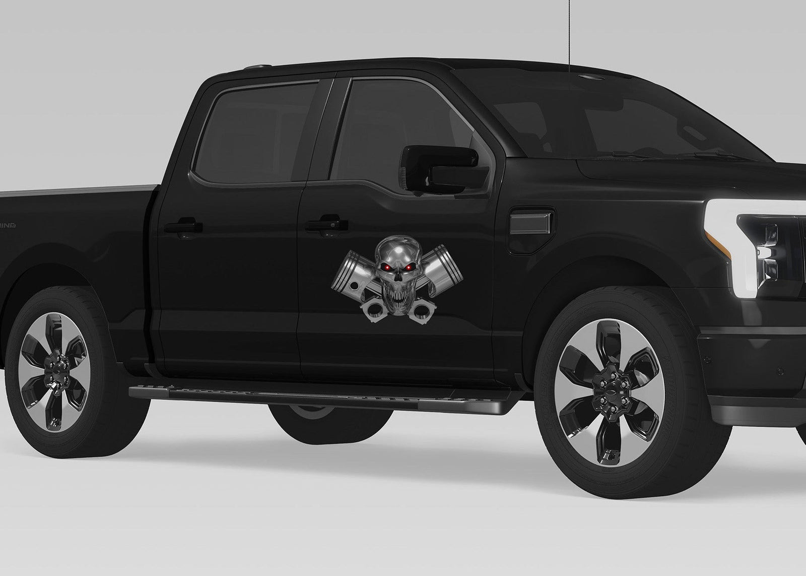 black truck with chrome skull and pistons vinyl graphics on passenger front door side