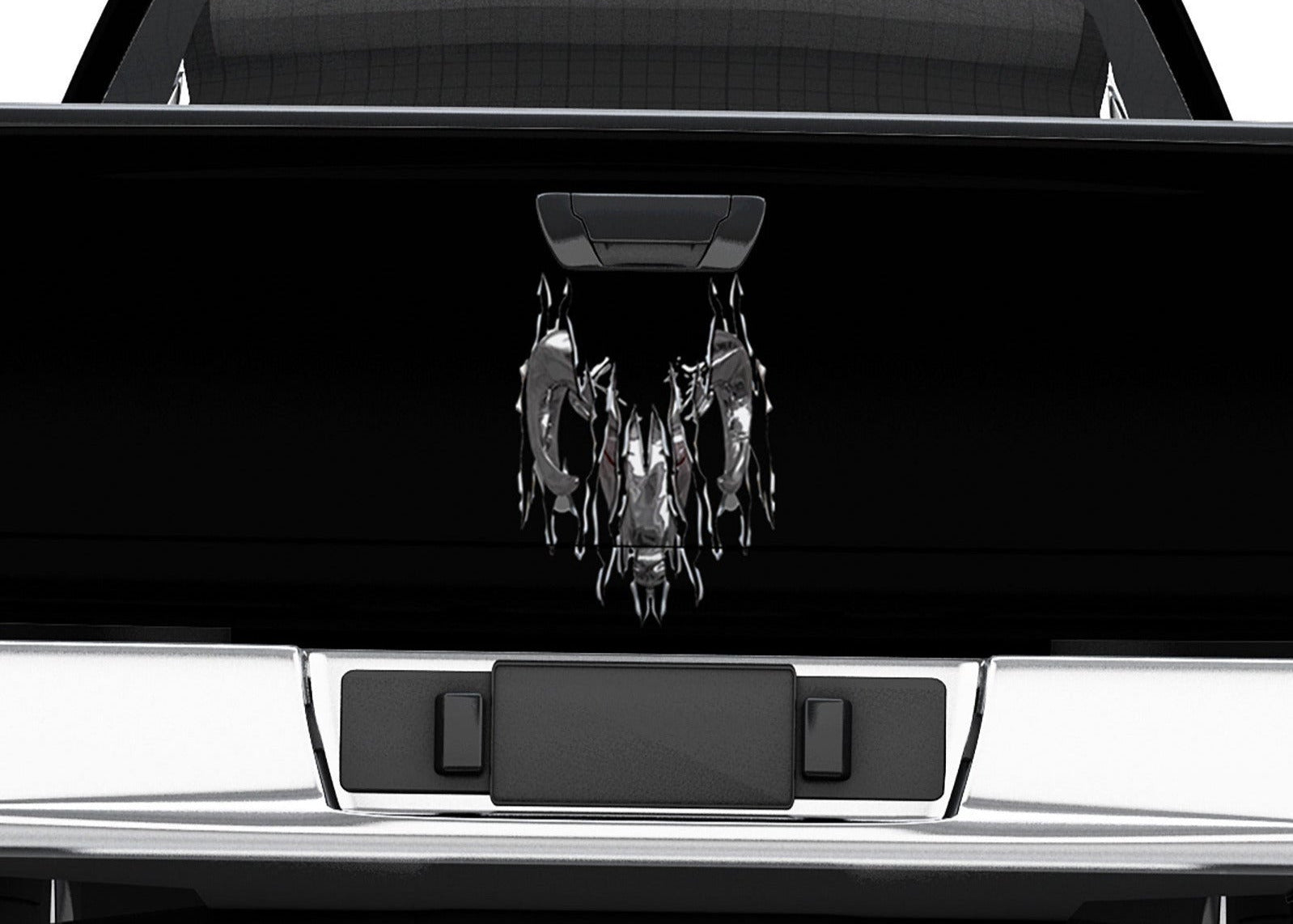 Black truck with a torn chrome ram head on tailgate