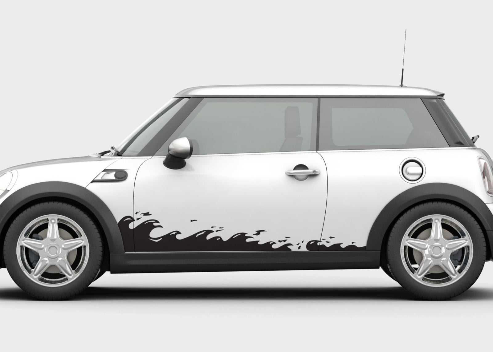 A car with a set of white ocean wave vinyl cut decals applied to the side doors.