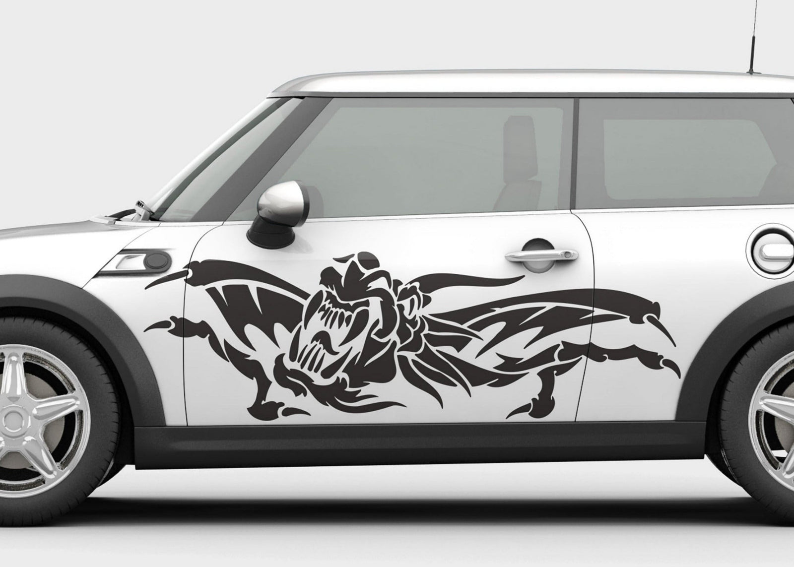 White car with black Oni Ryu Winged dragon decal on driver side