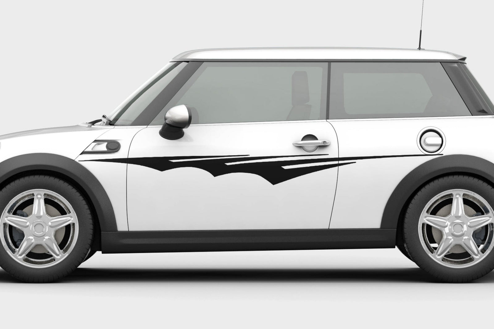 white mini cooper with black tribal spear vinyl cut decal on driver side