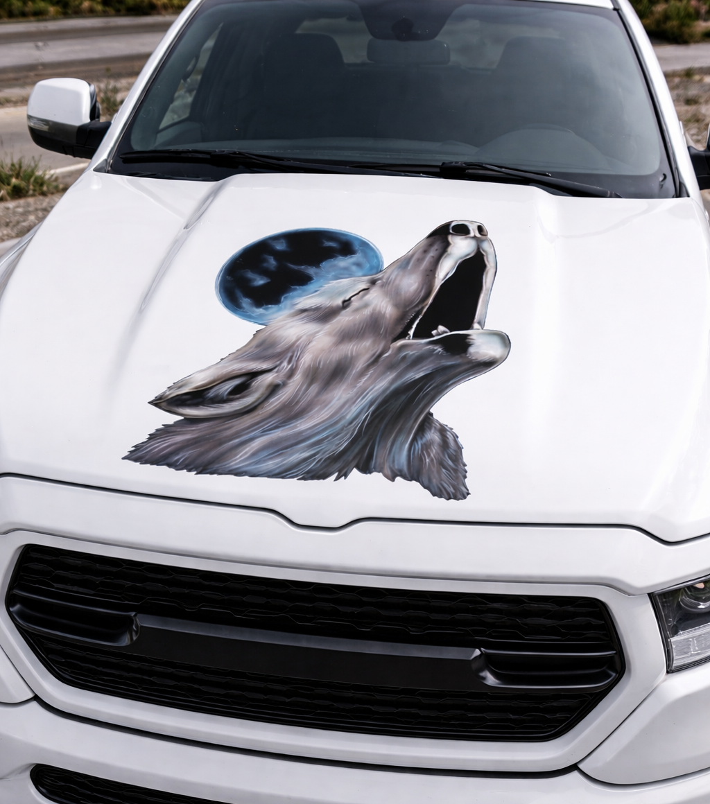 white truck with howling wolf mood decal on hood