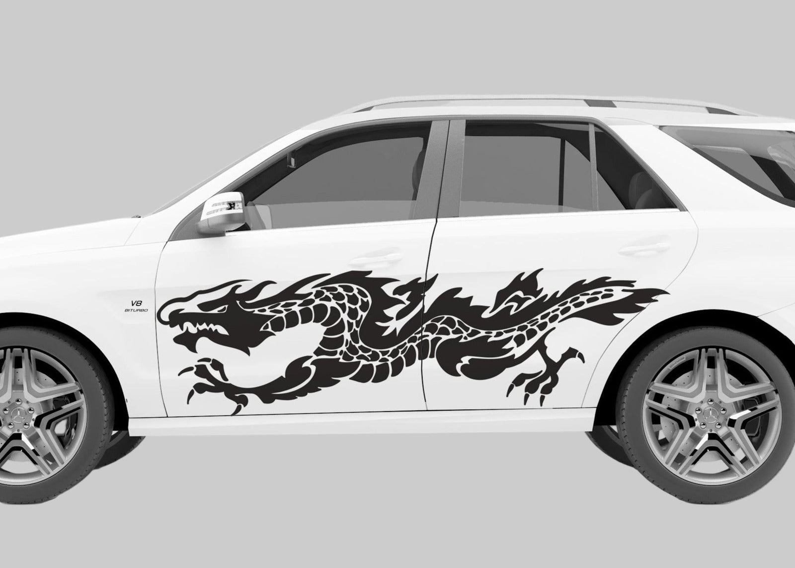 white SUV with black flaming dragon vinyl cut decal on driver side