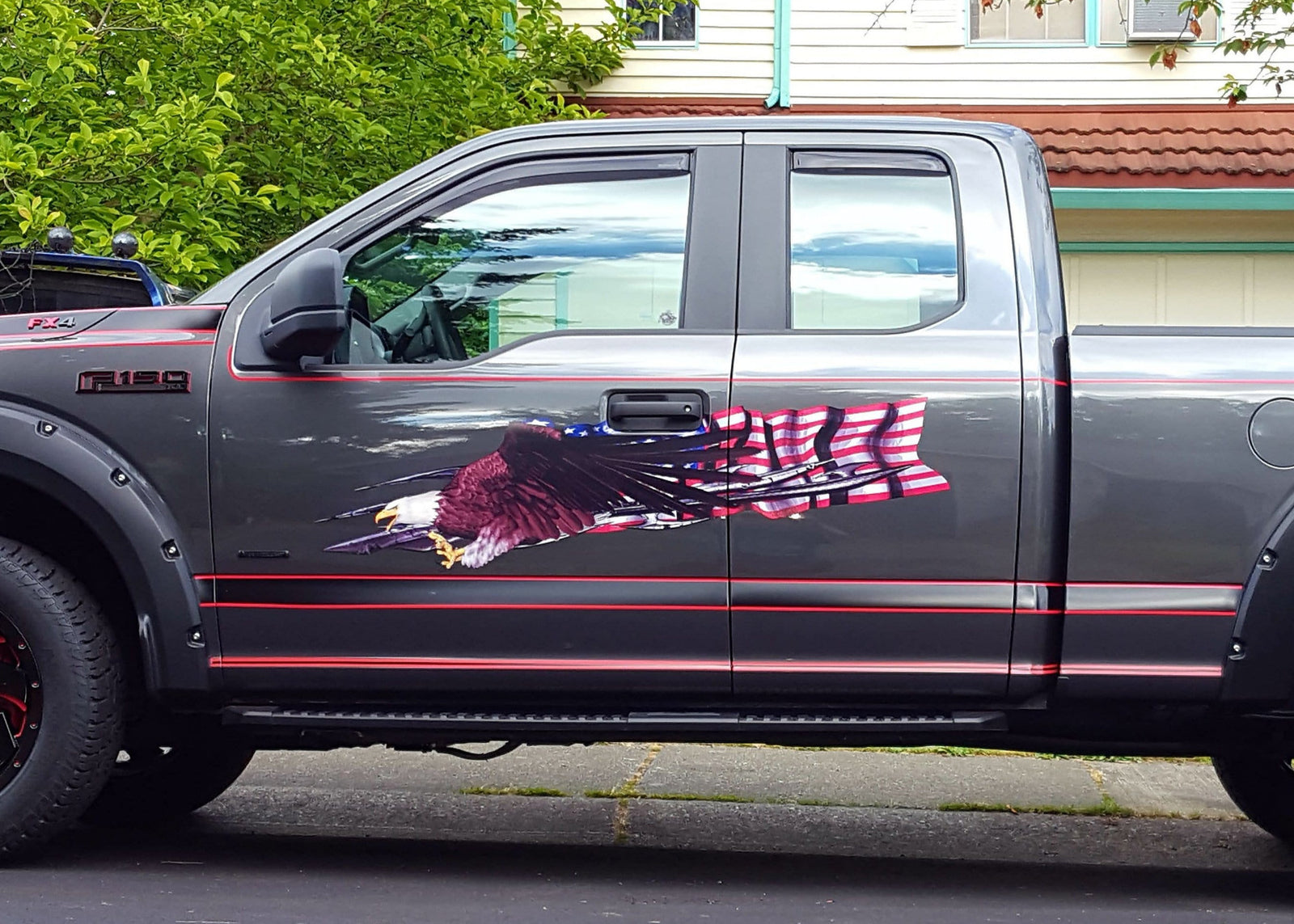 gray f150 ford truck with bald eagle american flag decal on cab side