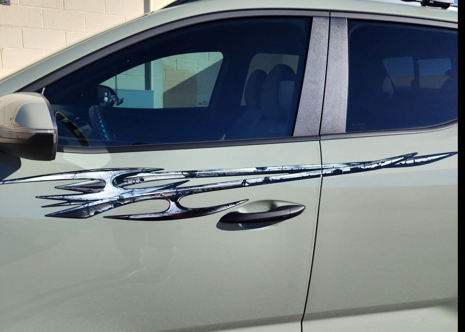 hyundai santa cruz truck with tribal edge graphics on it driver side, closeup view.