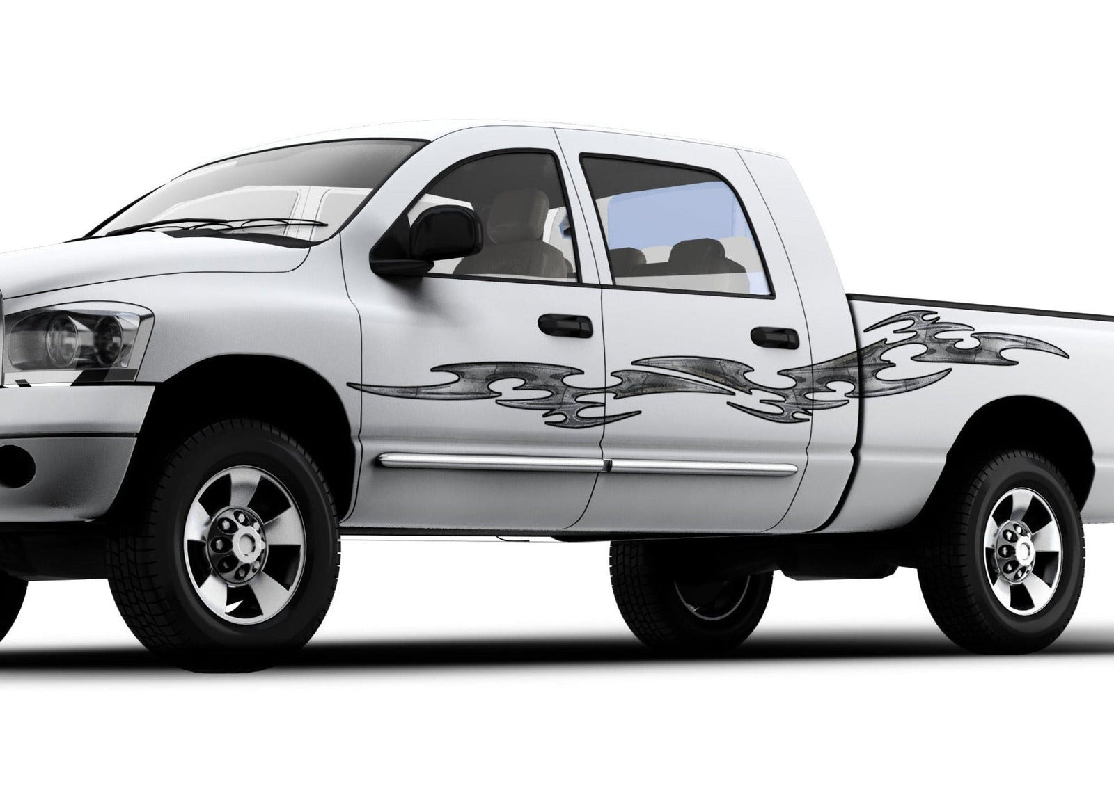 A white truck featuring grey vinyl graphic decals with a tribal link flame design on the driver side.