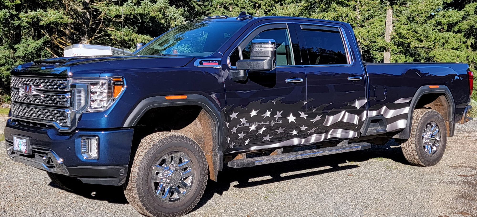 American flag black and white wrap on Blue Gmc Truck