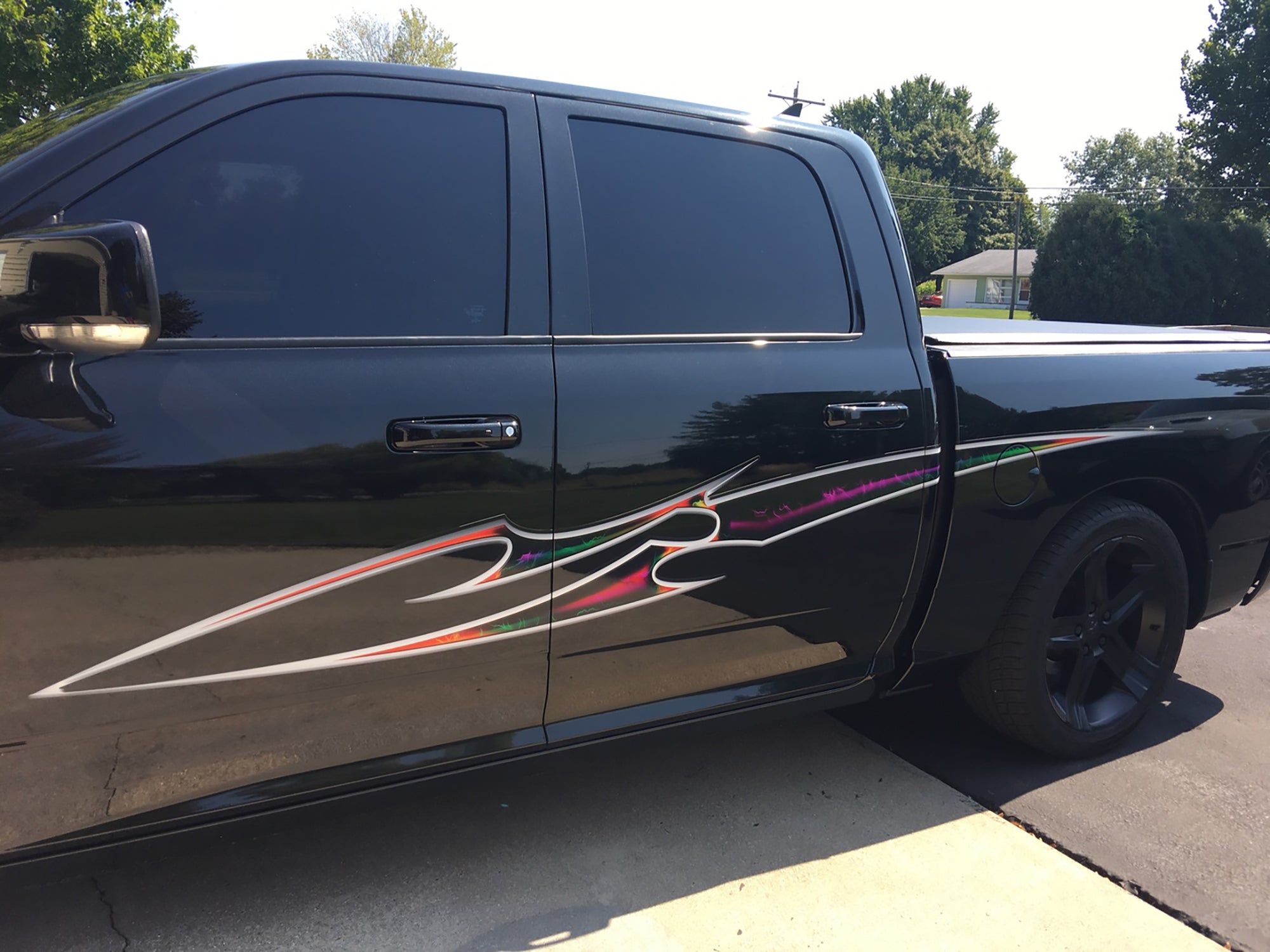 black vinyl cut decal Blade multi color stripe on black pickup truckstripe installed on red truck