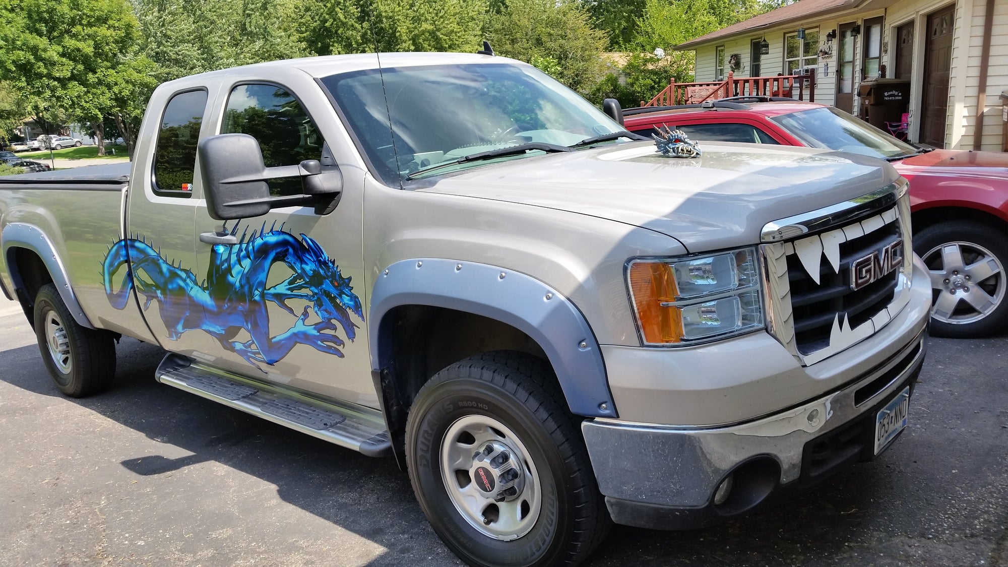 blue vinyl dragon decal on side of GMC truck
