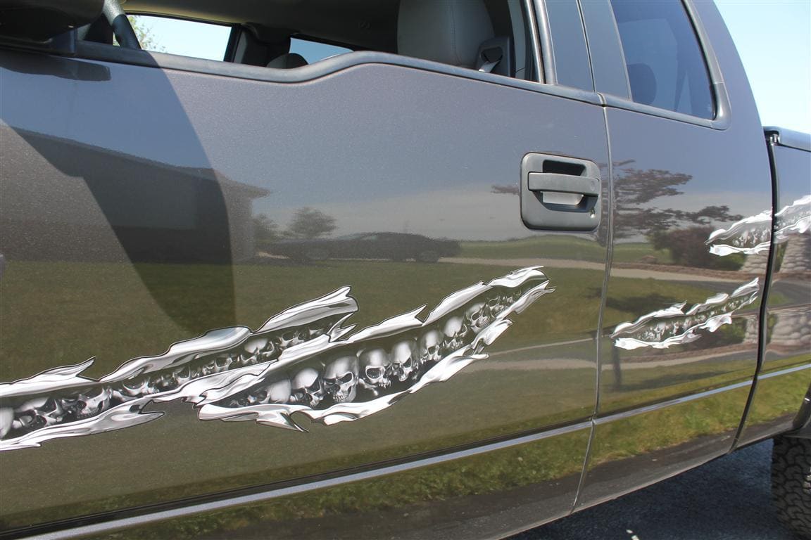 chrome skulls tears decal on the side of a gray pick up truck