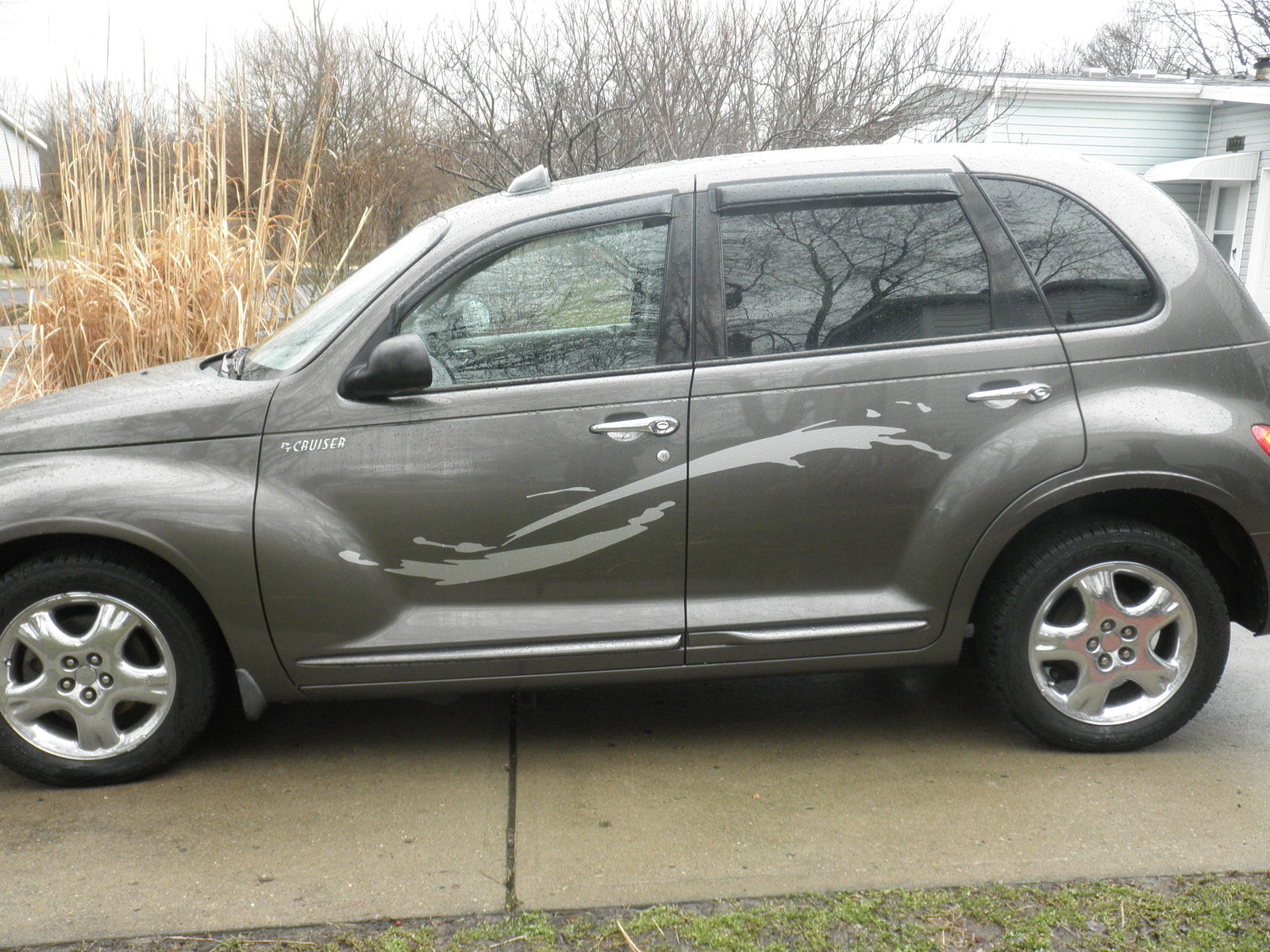 dark gray hatchback car with a light gray brush strokes cut vinyl decal on the side