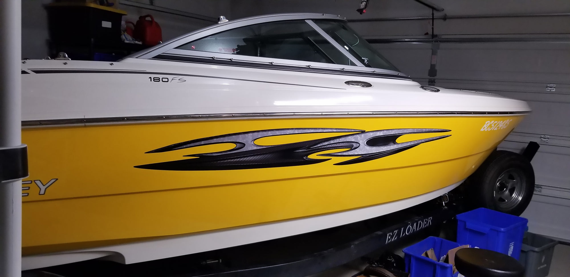 Tribal carbon fiber decal on side of yellow boat