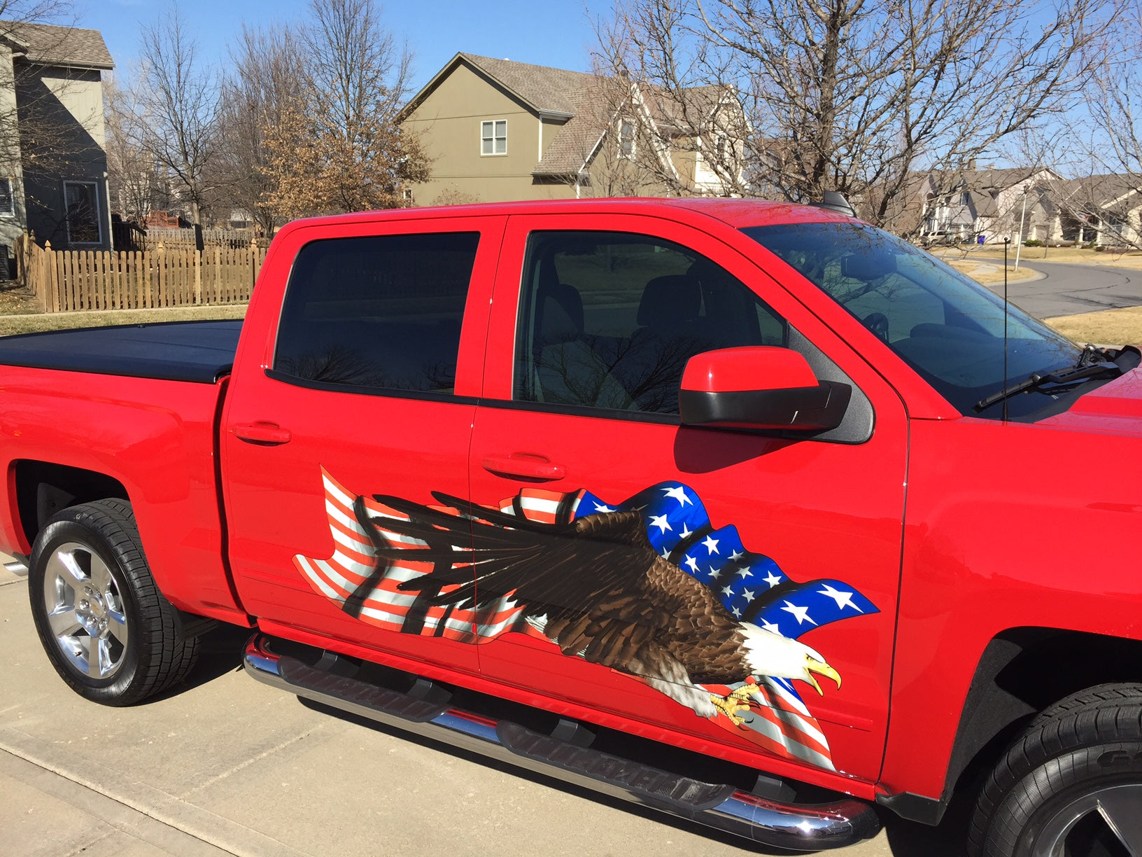 Bald eagle American flag decal on the side of a red pick up truck
