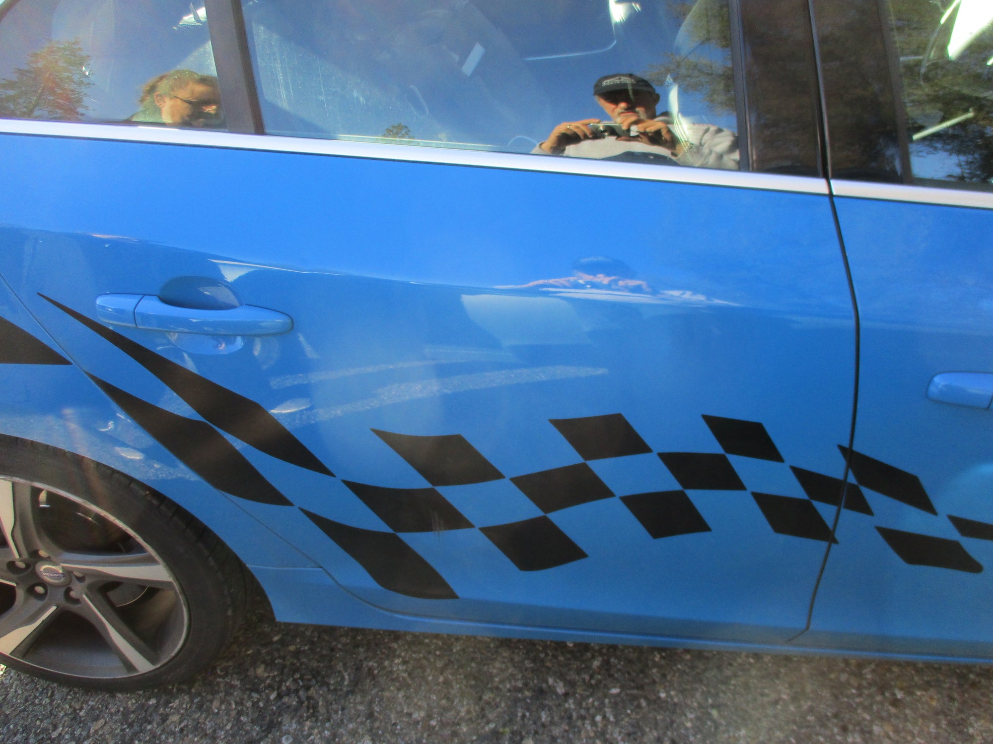 black checkered flag vinyl decal on the side of blue car
