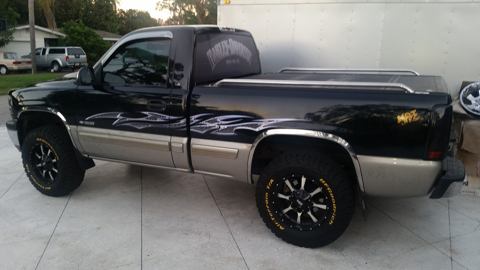 chrome grills decal on the side of a black pick up truck