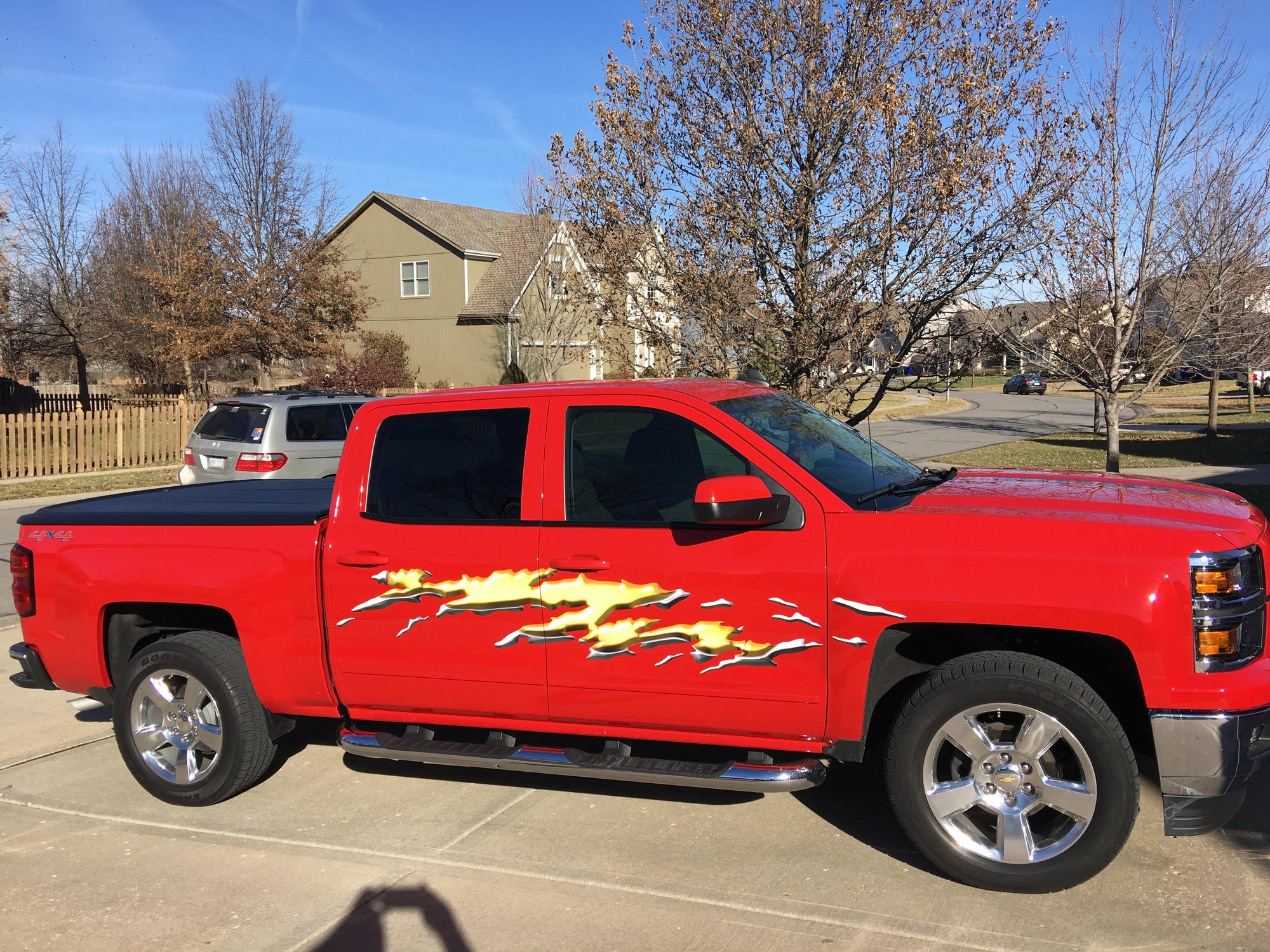 Gold mud splash decal on the side of red chevy truck