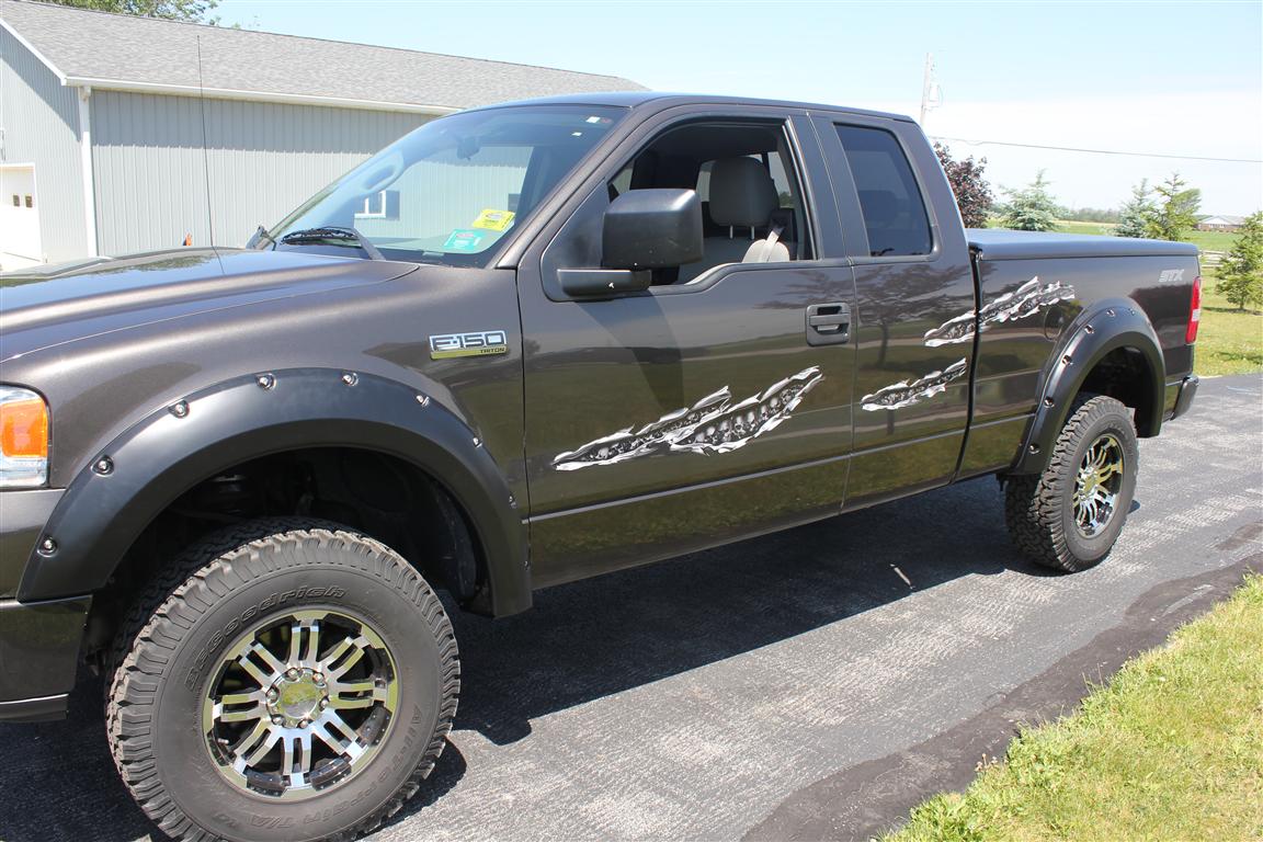 chrome skull tear decals on the side of a grey Ford F150truck