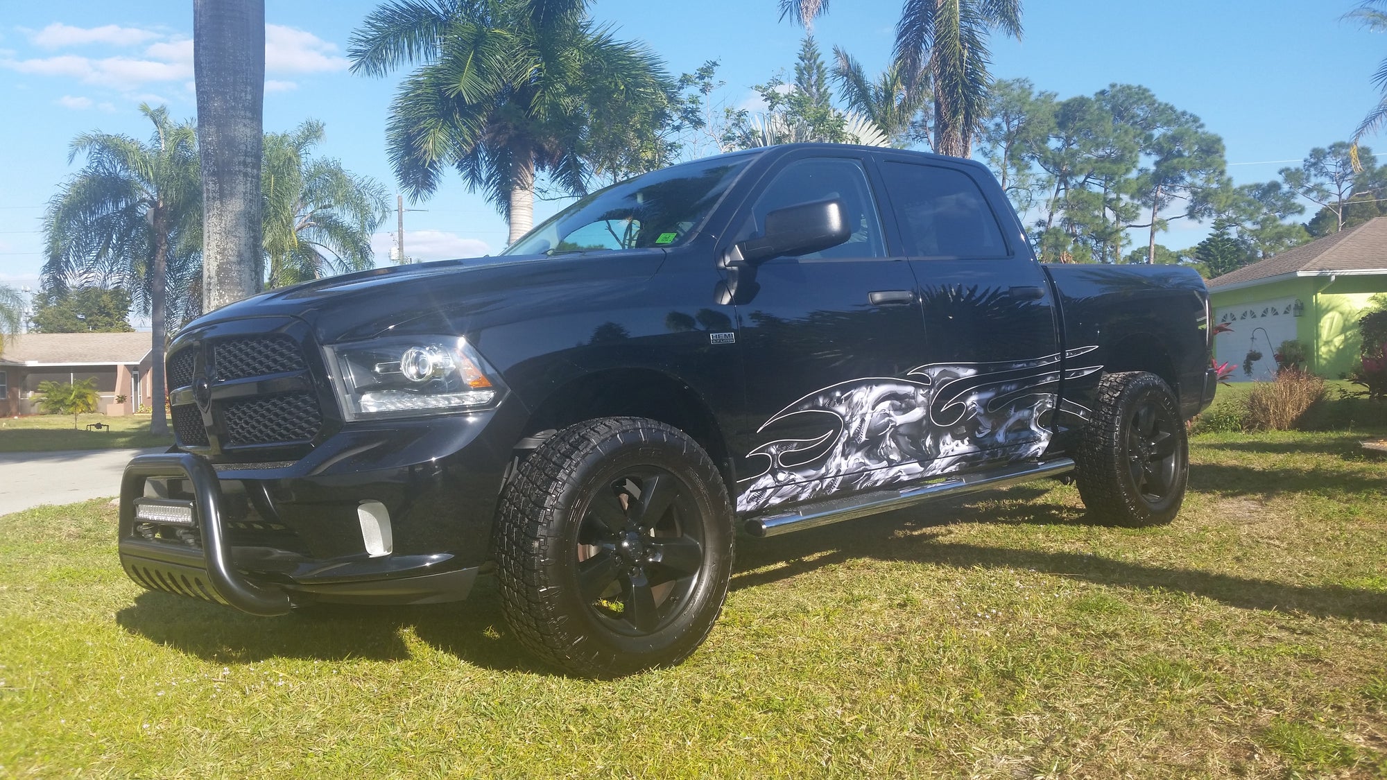 grey dragon attack half wrap on the side of a black dodge black truck