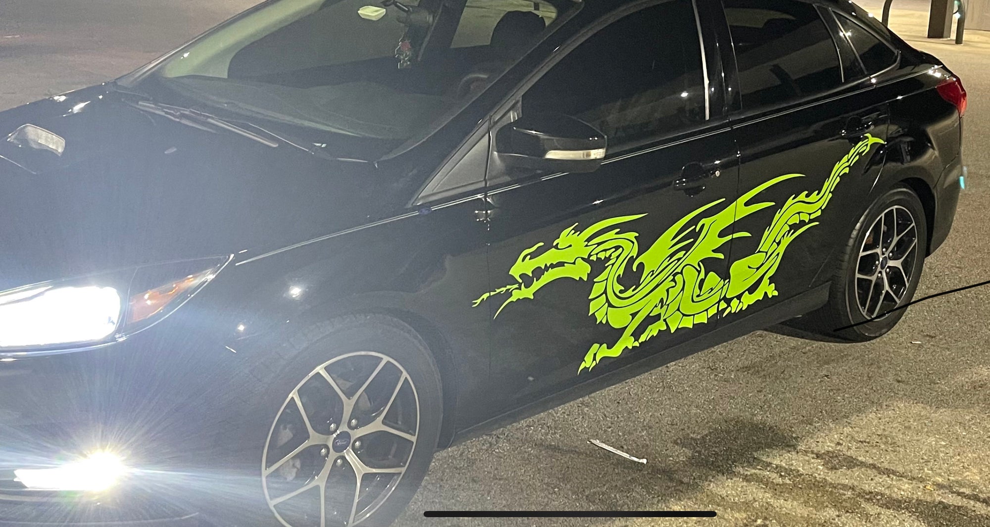 lime green dragon vinyl decal on black car
