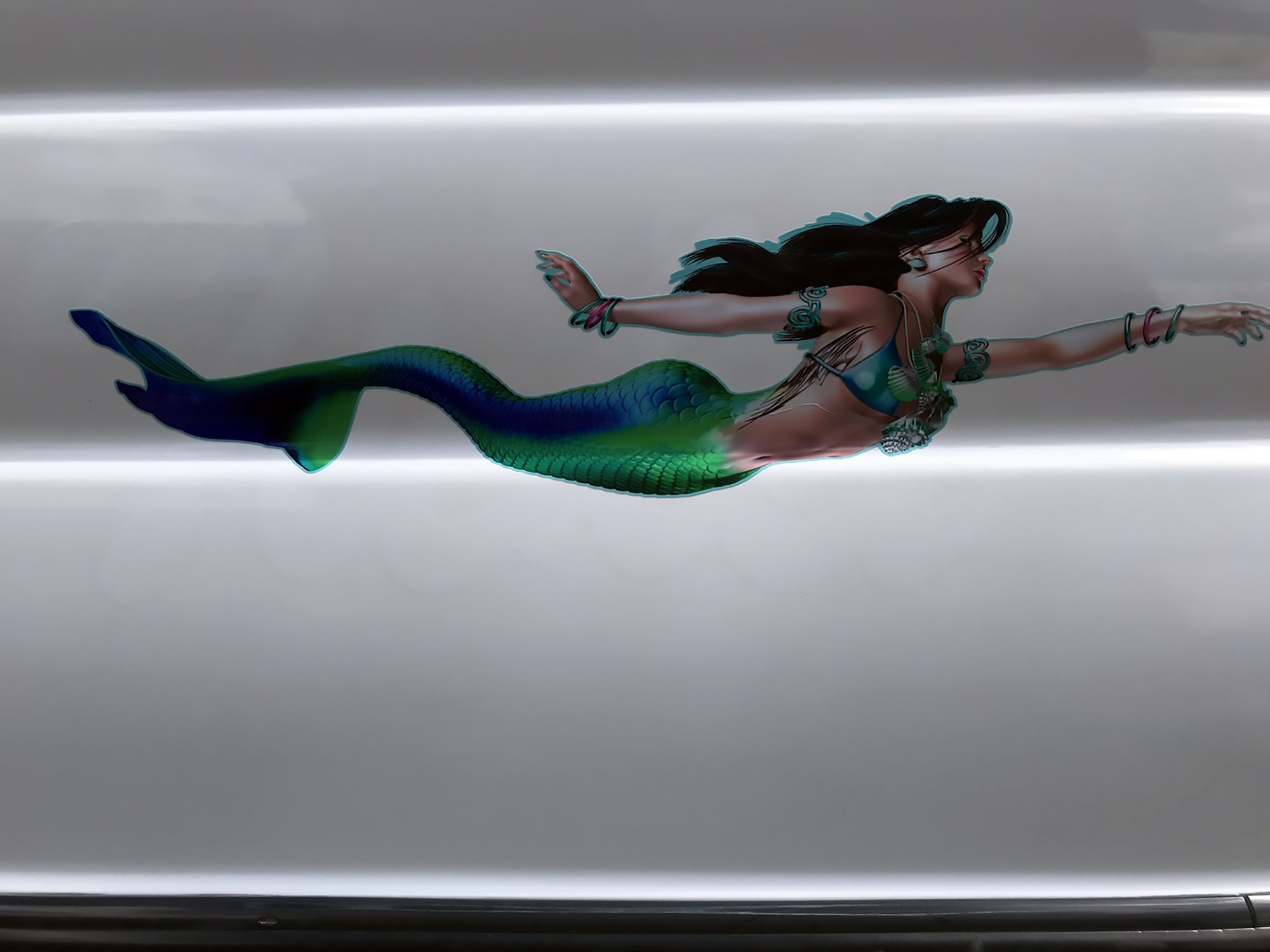 mermaid decal on the side of customer white boat