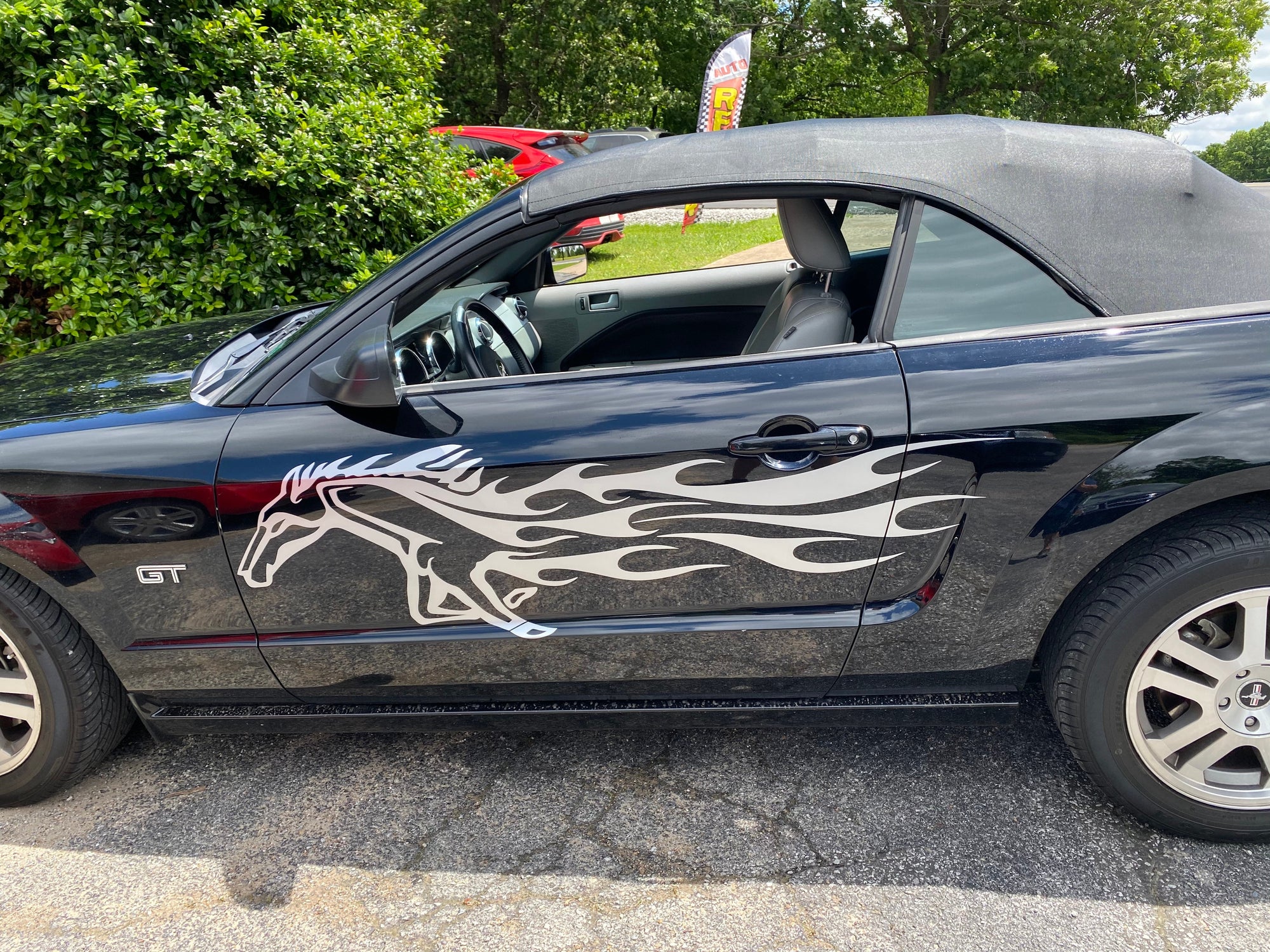 white horse flames decal on side of  black ford mustang gt
