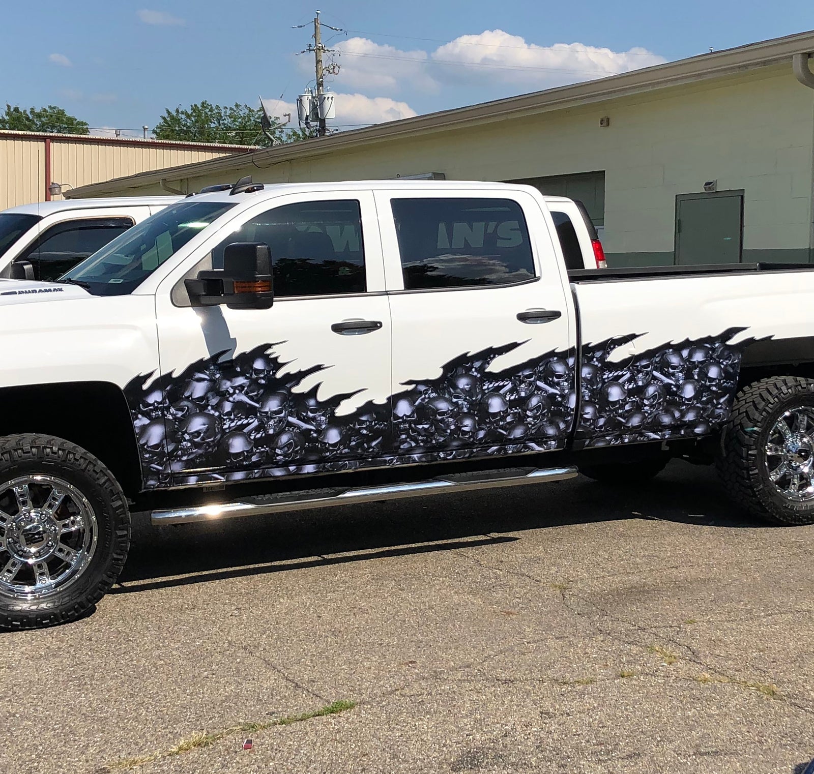 white chevy pickup truck with silver blue skulls flames half wrap on driver side