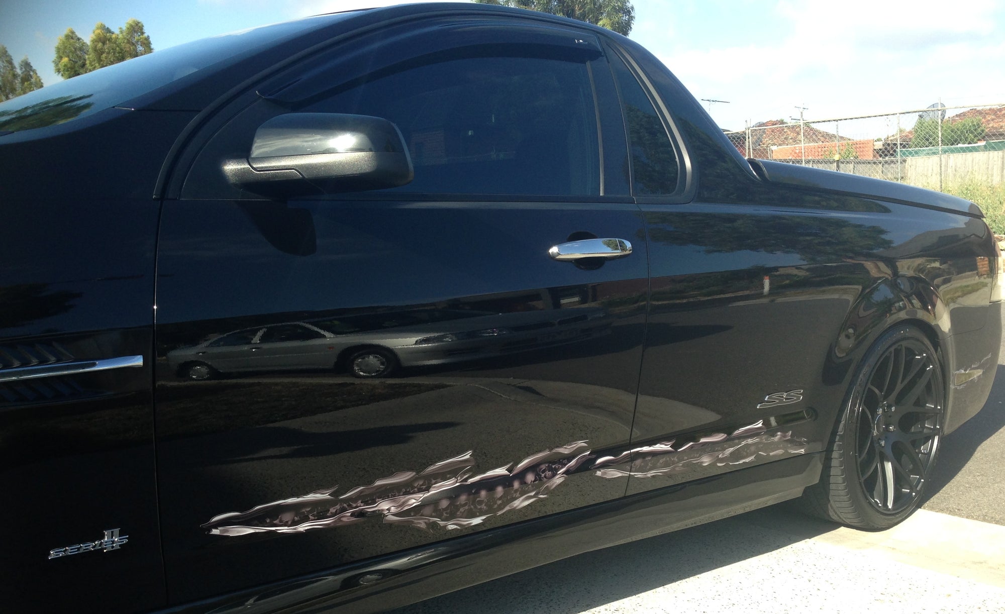 skulls tear decal of side of black Commodore utility vehicle