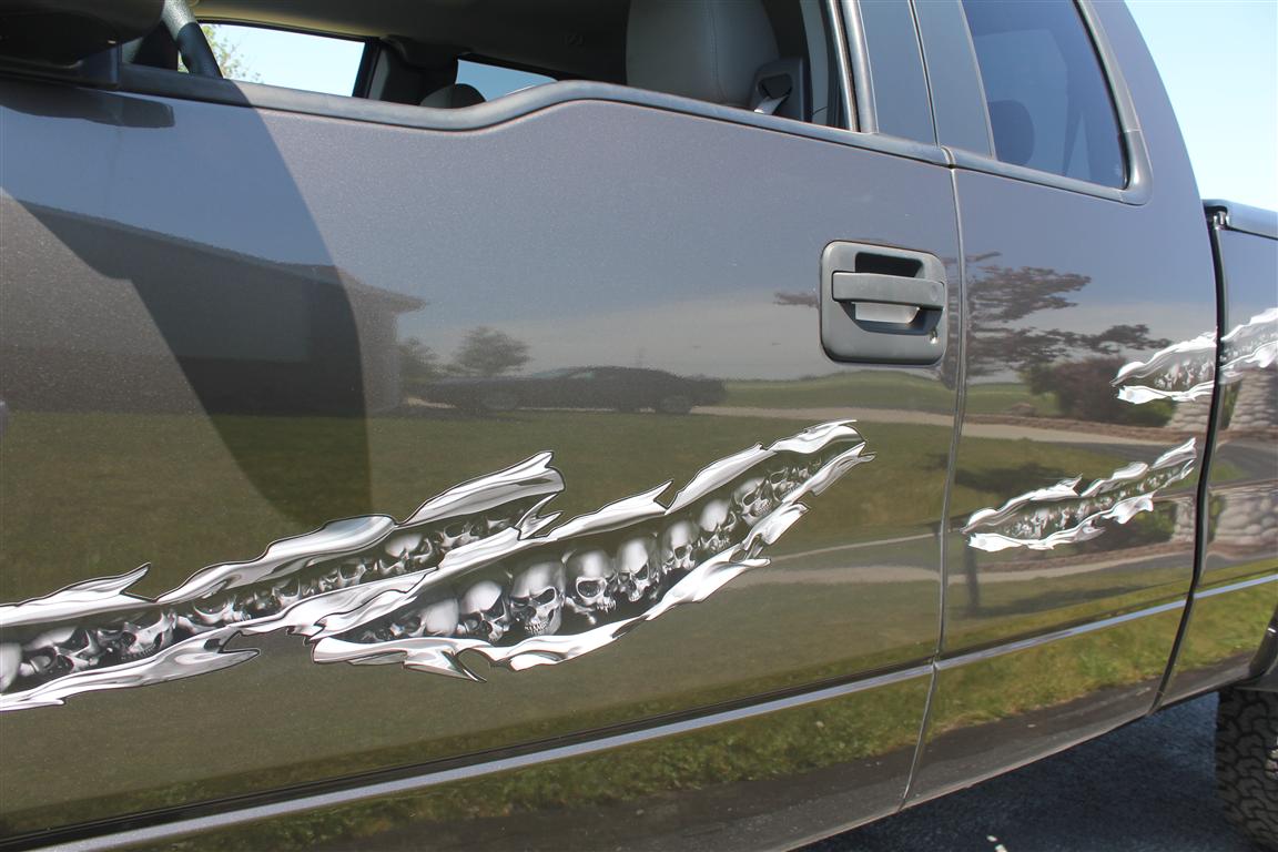 chromes skulls tear decal on the side of a dark grey pick up truck