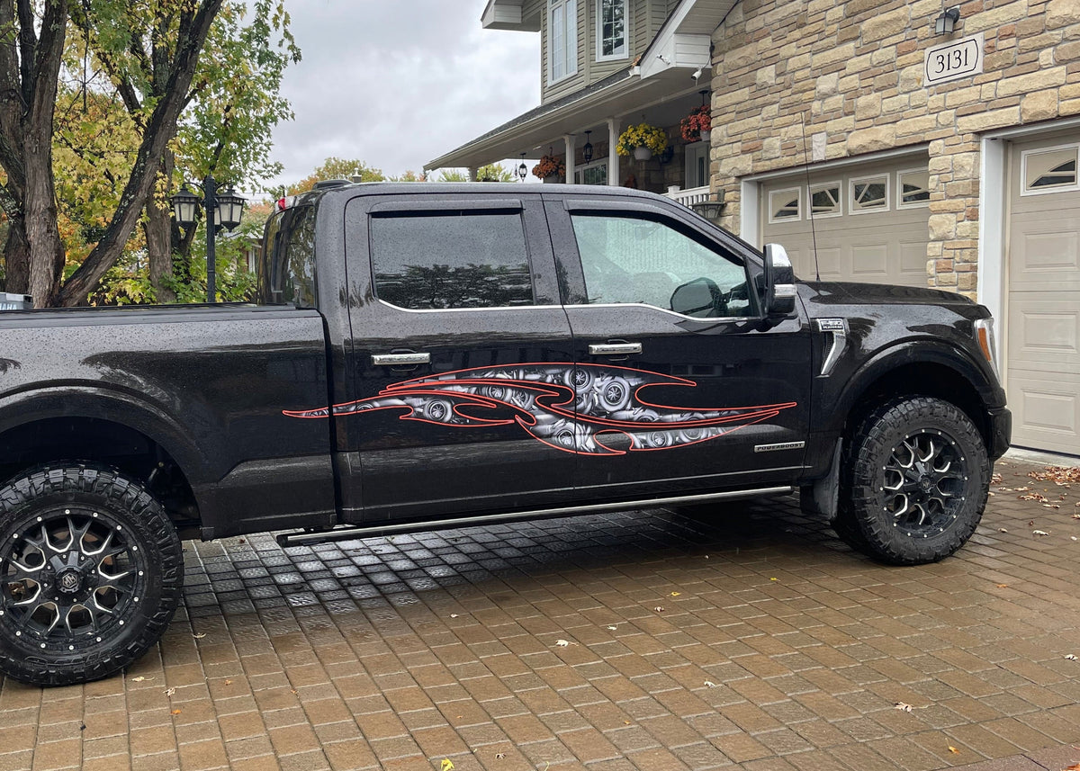 Full side view of black pickup with tribal steampunk vinyl decals installed