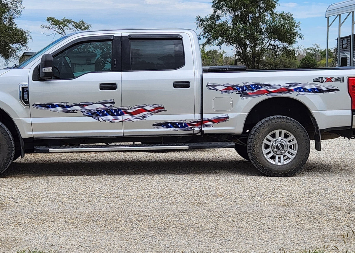 Full side view of pickup with American flag tear decals across doors and bedside