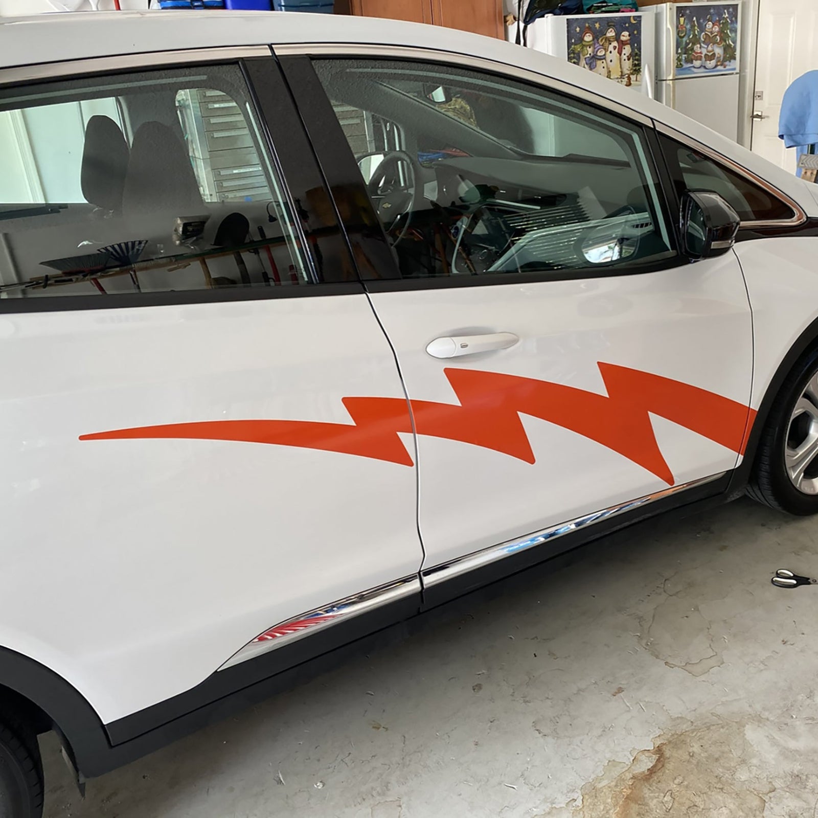 lightning bolt vinyl silver decal on the side of red bmw electric car