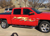 Mud splash gold decals on the side of red chevy Pickup