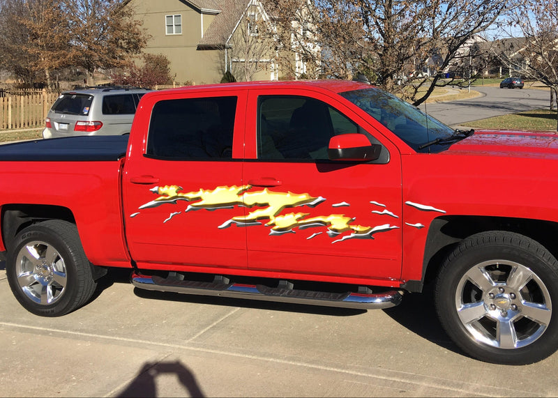 Mud splash gold decals on the side of red chevy Pickup