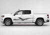 Silver and black Diamond Plate Strike vinyl graphic displayed along the driver side of a white four-door pickup truck.