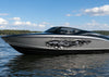 Silver and black speedboat on a lake with gray dragon tear boat decals on the hull.